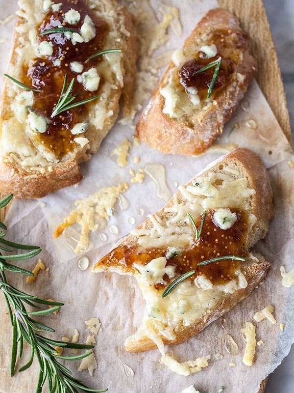 Melted cheese, fig jam, and rosemary on baguette